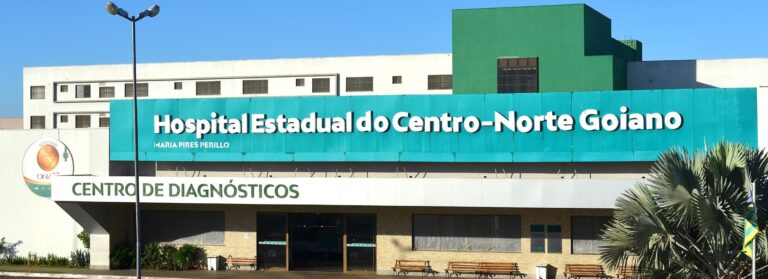 Fachada do Hospital Estadual do Centro-Norte Goiano HCN em Uruaçu iluminada em verde e amarelo para as campanhas de conscientização sobre câncer de cabeça e pescoço e hepatites virais.